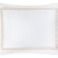 A white quilted pillow sham from the Matouk Astor Braid Matelassé Bedding Collection, featuring a Petra diamond matelassé pattern and a beige looped Astor Braid embroidery border, is photographed from above against a white background for an elegant, Schumacher-inspired look.