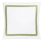 A white square plate from Matouk’s Astor Braid Bedding Collection, Grass features a green looped border design around the edge.