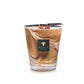 The Baobab Collection Atlas Tichka Candle, in a glass jar with a brown swirl pattern and a black "Baobab Collection" label, offers earthy scents of vetiver and patchouli.