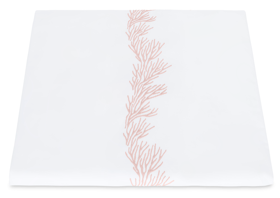 White napkin from the Matouk Atoll Bedding Collection in Blush with an embroidered coral branch pattern.