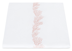 White napkin from the Matouk Atoll Bedding Collection in Blush with an embroidered coral branch pattern.