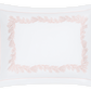 The Atoll Bedding Collection pillowcase by Matouk features blush Ceylon cotton percale and a feathery coral embroidery forming a delicate rectangular border.