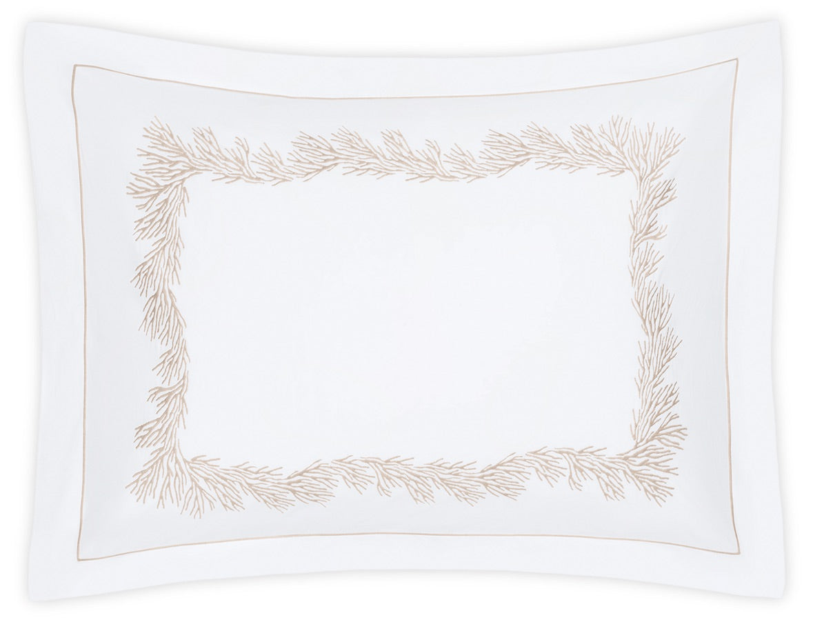 The Atoll Bedding Collection pillowcase by Matouk is a white rectangular design crafted from luxurious CEYLON cotton percale. It features a decorative beige coral-inspired embroidered border and a thin beige outline near the edge, all in a sumptuous 520 thread count for exceptional comfort and elegance.