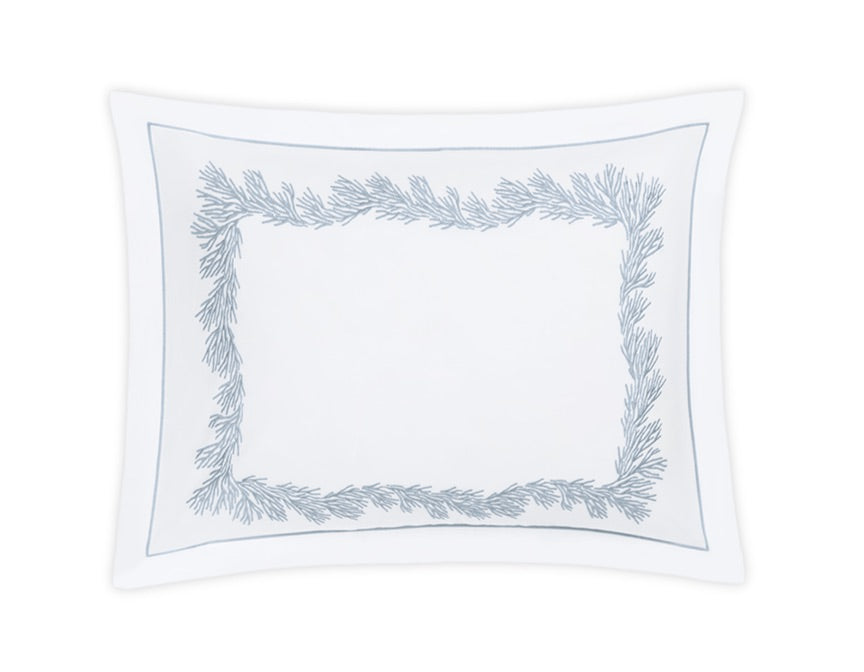 The Atoll Bedding Collection by Matouk features a white rectangular pillowcase adorned with a blue, leafy embroidered pattern along the border and accented with a thin blue outline near the edge. Expertly crafted from luxurious CEYLON cotton percale with a 520 thread count, it is displayed on a plain white background.