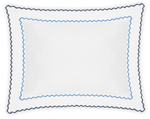 The Axel Boudoir Sham by Matouk is a white rectangular pillow with scalloped edges, blue zigzag embroidery near the edge, and a darker trim. Made from soft long-staple cotton, it adds modern elegance to any room. Shown on a plain background.