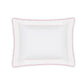 Part of the Axel Bedding Collection by Matouk, this white rectangular pillow features a scalloped edge with a pink border and delicate zigzag embroidery, shown against a white background.