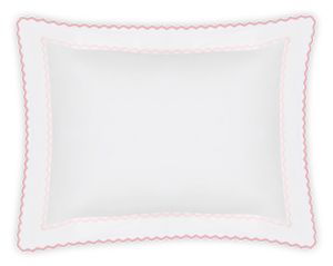 The Axel Boudoir Sham by Matouk is a white rectangular pillow made from long-staple cotton, featuring a scalloped pink border with zigzag embroidery for a playful, modern accent. Shown against a plain white background.