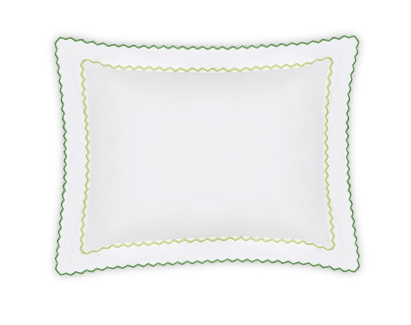 The Axel Bedding Collection by Matouk features a white rectangular pillowcase with scalloped edges and double green zigzag embroidery, crafted from soft long-staple cotton—an elegant touch for a modern bed. Shown on a white background.