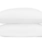 Two white pillows from the Axel Bedding Collection by Matouk are stacked together, each made from luxurious long-staple cotton and accented with a green zigzag embroidery along one edge on the right side—perfect for elevating the look of any modern bed.