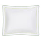 The Axel Bedding Collection by Matouk features a white rectangular pillowcase, crafted from soft long-staple cotton, and finished with scalloped green and yellow zigzag embroidery along the edges, shown on a plain white background.