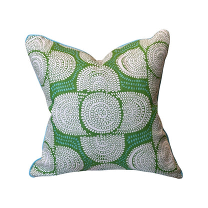 The Azteque Green Pillow by HIVE ALTERATIONS features a handmade green design with white dotted circles, light blue piping, and 100% down filling—adding comfort and style to any space.