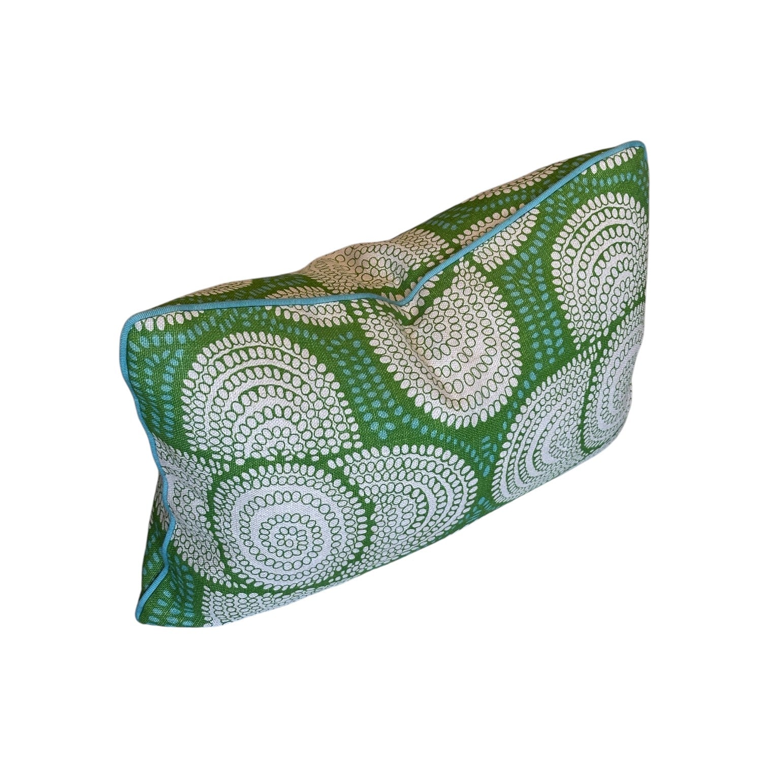 The Azteque Green Lumbar Pillow by Hive Custom Pillows is a rectangular handmade pillow featuring a green background with white circular dots and blue edge piping.