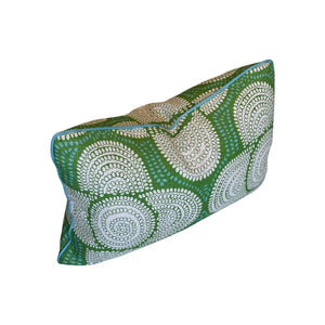 The Azteque Green Lumbar Pillow by Hive Custom Pillows is a rectangular handmade pillow featuring a green background with white circular dots and blue edge piping.