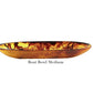 The Tortoise Resin Serveware Collection by Nashi Home features a medium, shallow oval bowl with a marbled amber-brown finish in shatter-resistant resin—ideal for stylish decor. Labeled "Boat Bowl Medium" on the base.