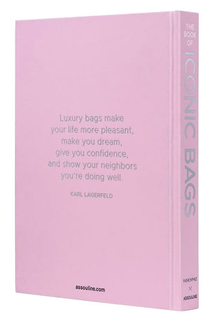 A pink hardcover book, "Fashionphile: The Book of Iconic Bags" by Assouline, features a Karl Lagerfeld quote on luxury accessories and investment handbags on the front cover.