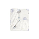 The Gooselings Touch the Sky Bedding Collection features a white fitted sheet adorned with pastel hot air balloons, clouds, and birds, crafted from pure materials and neatly folded against a plain white background.