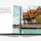 The Assouline "Bangkok Spirit" book features a quote on the left page and a photo of a traditional Thai pavilion by a pool on the right, encapsulating Bangkok's charm.