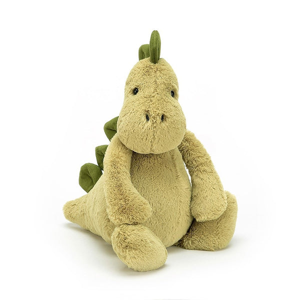 Jellycat Bashful Dino, a small stuffed dinosaur sitting on a white background.