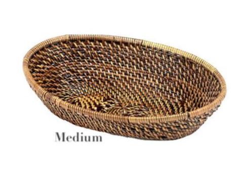 The Calaisio Oval Bread Basket Collection features medium-sized, oval baskets handcrafted by skilled artisans with eco-crafted, tightly woven brown and tan fibers.