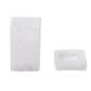 The Nashi Home Bath Collection in Swirl White features two white objects: a tall, standing container and a flat, square dish with rounded edges. Their translucent design, evoking resin collections, captures the serene beauty of Sydney beaches.