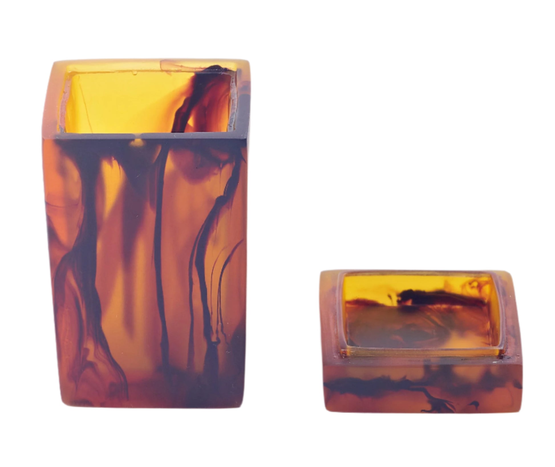 Two translucent amber-colored square containers, one upright and one on its side, are evocative of the vibrant colors at Sydney beaches. These are part of the Nashi Home Bath Collection, Tortoise by Nashi Home.