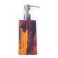 The Nashi Home Bath Collection Tortoise soap dispenser features a vibrant marbled amber and black design with a silver pump, reminiscent of Sydney beach hues.