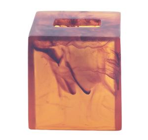 The Tortoise Resin Bath Collection by Nashi Home features a translucent amber, marbled resin cube with a square top hole—elegant and inspired by aqua water and Sydney beaches, perfect for refined bath decor.