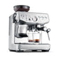 The Breville Barista Express Impress Espresso Machine features a built-in grinder, steam wand, two glass cups, and a coffee bean hopper—ideal for making specialty coffee at home.