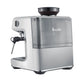 The Breville Barista Express Impress Espresso Machine features a silver finish, integrated bean hopper, steam wand for microfoam milk, and a transparent water reservoir.