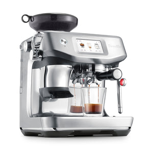 The Breville Barista Touch Impress Espresso Machine, made of stainless steel with a digital display and ThermoJet heating, brews two espressos into glass cups.