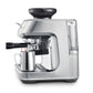 The Breville Barista Touch Impress Espresso Machine features the innovative Impress Puck System, a stainless steel body, attached portafilter, milk frothing pitcher below, and a visible water reservoir on the right.