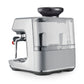 The Breville Barista Touch Impress Espresso Machine is a compact stainless steel unit featuring a transparent water tank and a left-side steam wand for creating microfoam milk.