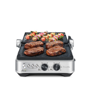 The Breville Sear & Press Grill doubles as a panini press and cooks four steaks plus veggie and meat skewers on its nonstick surface.
