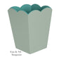 The Addison Ross Scalloped Lacquer Waste Bin Collection features a decorative container with a greenish-blue scalloped edge, elegantly labeled "Eau de Nil + Turquoise.