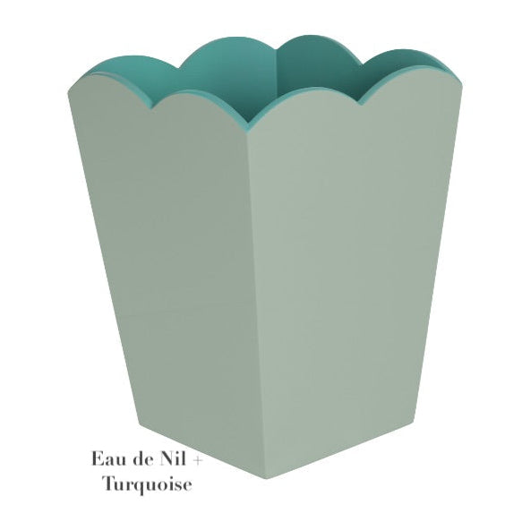 The Addison Ross Scalloped Lacquer Waste Bin Collection features a decorative container with a greenish-blue scalloped edge, elegantly labeled "Eau de Nil + Turquoise.