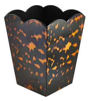 The Scalloped Lacquer Waste Bin Collection by Addison Ross features a hexagonal, scalloped design with a brown and amber tortoiseshell pattern, inspired by the brand's signature style.