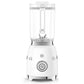 A sleek Smeg Blender Collection piece featuring dual metal blades and a clear plastic container, complete with a large round start/stop button on its base.