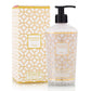 A Baobab Collection Women Body Wellness Collection lotion bottle with a pump sits beside its matching box, offering a floral fragrance that delights the senses.