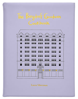 The Bergdorf Goodman Cookbook, Leather Bound" by Graphic Image is a luxury lavender cookbook featuring the iconic building's line drawing on its cover and includes favorite BG restaurant recipes.