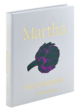Graphic Image’s "Martha: The Cookbook, Leather Bound" features a gold title and artichoke illustration on a light gray cover and is filled with favorite Martha Stewart recipes.
