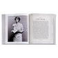 The Leather Bound "Martha: The Cookbook" by Graphic Image lies open, featuring a black-and-white photo of a woman with a soufflé on one page and the "A Lofty Soufflé" recipe on the other, inspiring your next favorite dish.