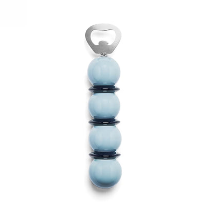Addison Ross Bobbin Bottle Opener Collection: A stylish bottle opener with a stainless steel top and a handle of four stacked light blue spheres accented by black rings, beautifully presented against a white background—an elegant gift for any occasion.