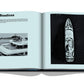 An open book from Assouline’s Burgess Yachts shows a “Boadicea” page with text and two black-and-white photos—a yacht with a helicopter, and an aerial view at sea—providing a window into the world of luxury superyachting.