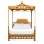 The Bunny Williams Rattan Trellis Canopy Bed features a striking lattice design, decorative headboard, white pillows, and a white mattress, shown against a plain background.