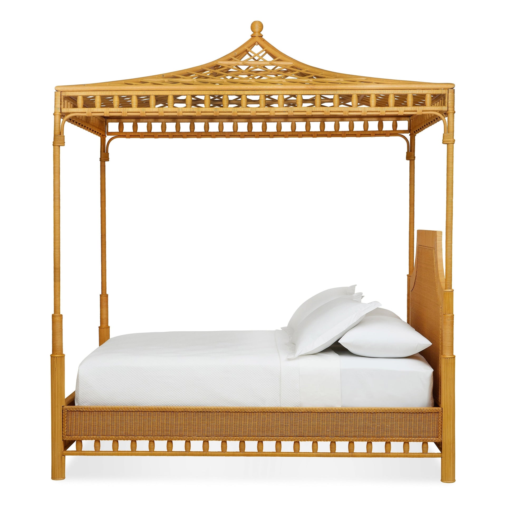 The Bunny Williams Rattan Trellis Canopy Bed features an intricate lattice canopy top, white bedding, and a light wood headboard, shown from the side.