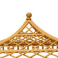 Close-up of a decorative wooden structure with an elegant lattice design and pointed top, echoing the Bunny Williams Rattan Trellis Canopy Bed, shown against a white background.