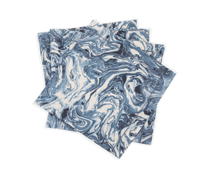 A set of four Balthazar Napkins by Matouk, featuring a striking blue and white marbled pattern, are stacked unevenly against a white background—bringing an elegant and sophisticated touch to your table setting for any occasion.