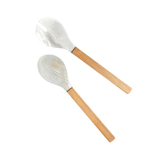 The Shell and Bamboo Serving Collection by Be Home features two ethically crafted salad servers with light brown bamboo handles and silver heads—one forked, one a spoon—showcasing organic beauty against a white background.