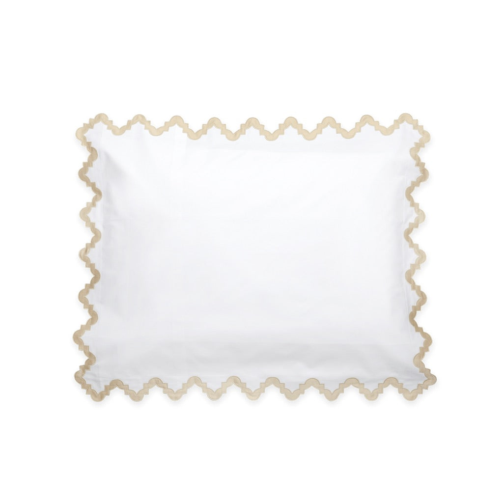 Matouk Aziza Bedding Collection, Champagne, featuring a white Egyptian cotton pillowcase with a scalloped tan border and Moroccan tile-inspired detailing.