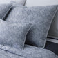 Navy Duma Diamond Bedding Collection by Matouk, featuring Egyptian cotton percale sheets and pillowcases, is elegantly arranged on the bed for a luxurious look.